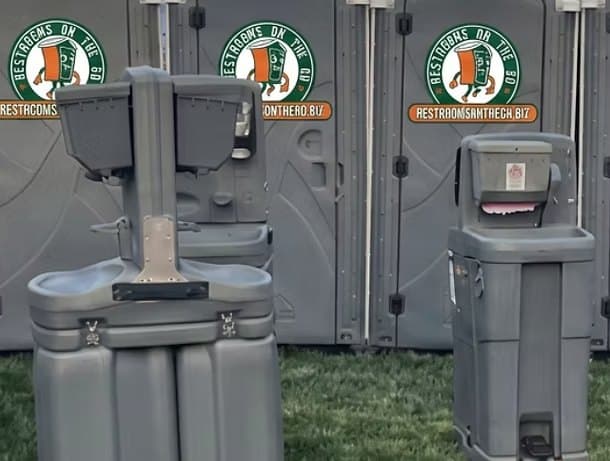 Handwashing stations in front of portable restrooms ready for deployment