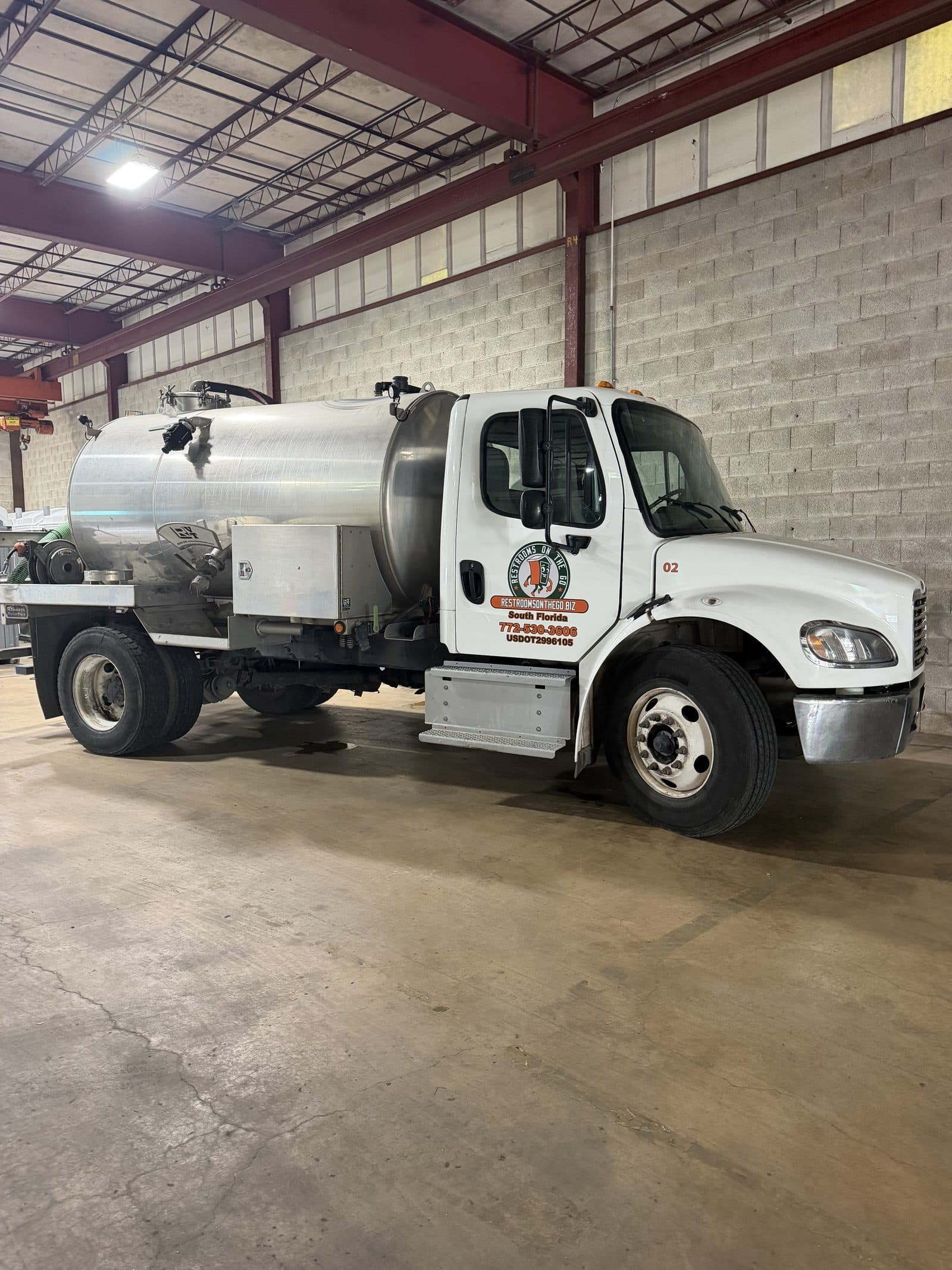 Restrooms On The Go South Florida vacuum pump truck with the company logo on the door